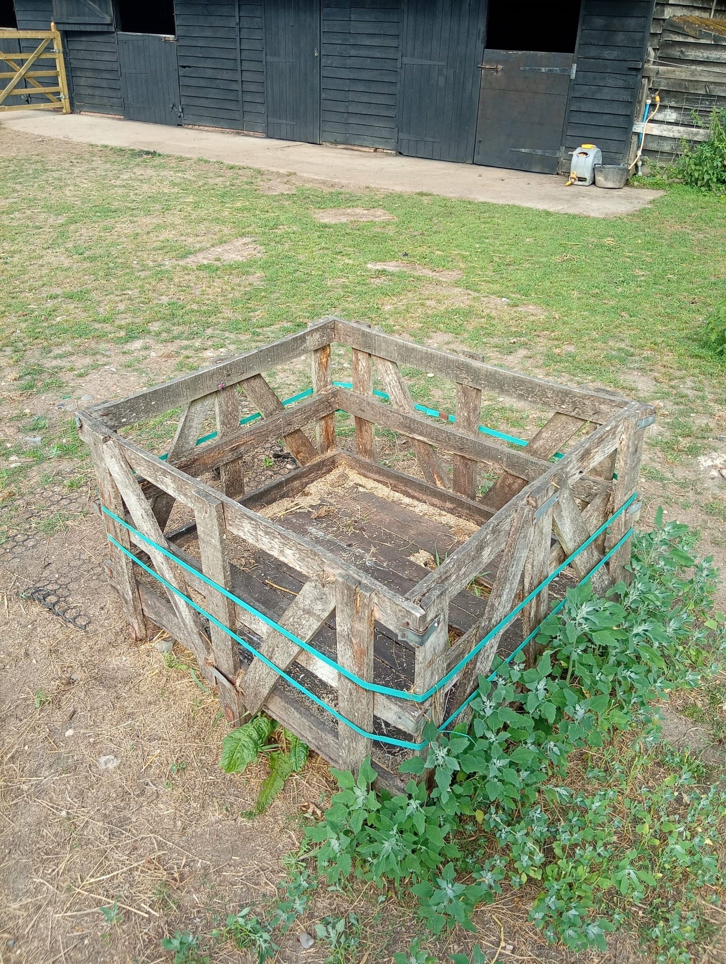 The same pallet crate in the paddock, emptied down to the bare boards